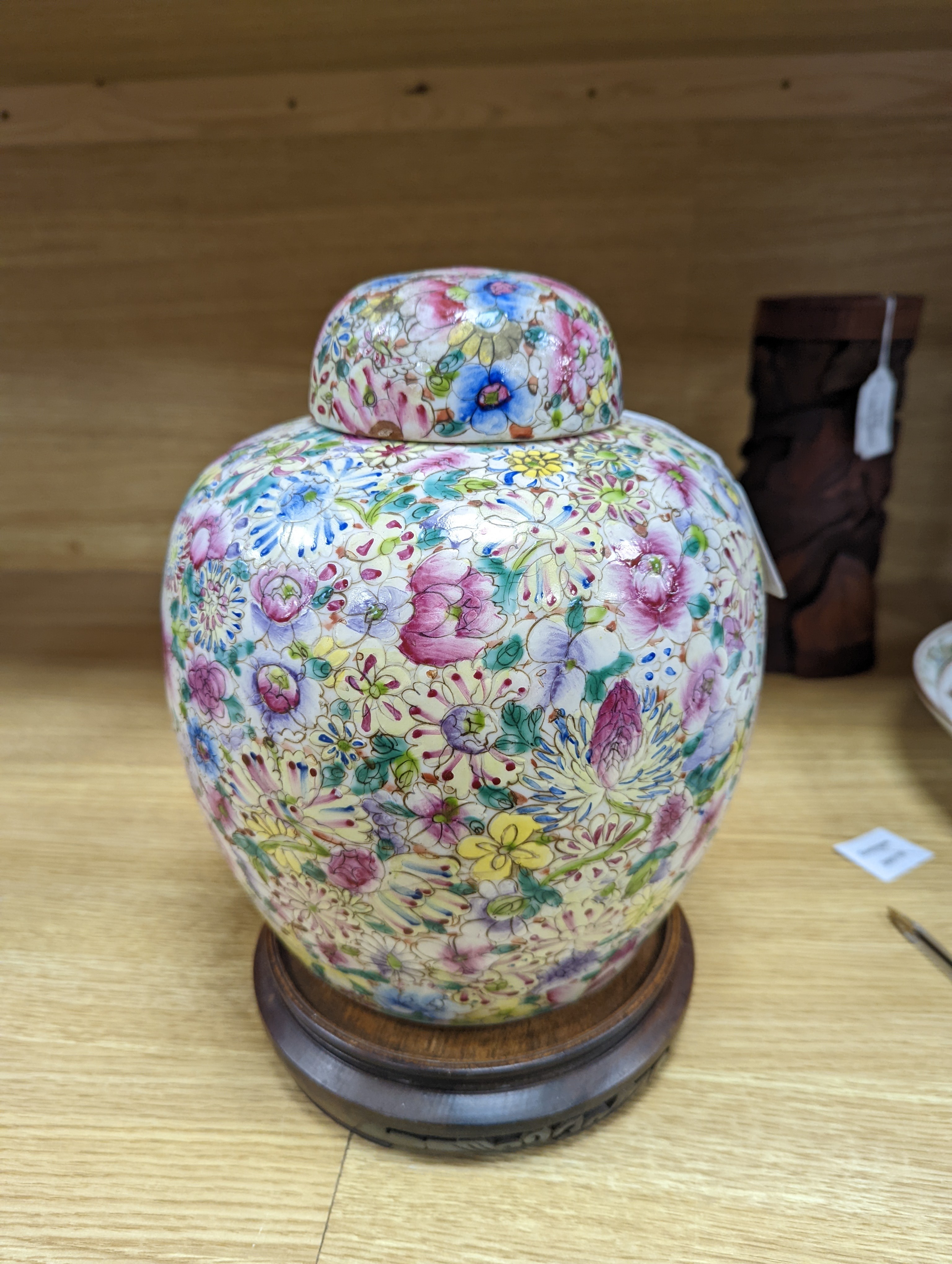 A Chinese thousand flower famille rose jar and cover, early 20th century, wood stand 28cm